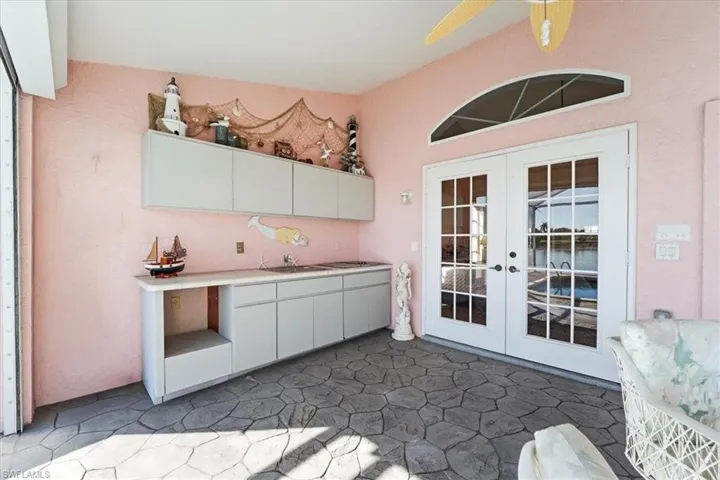 Summer kitchen on Lanai with automatic roll down hurricane shutters shown
