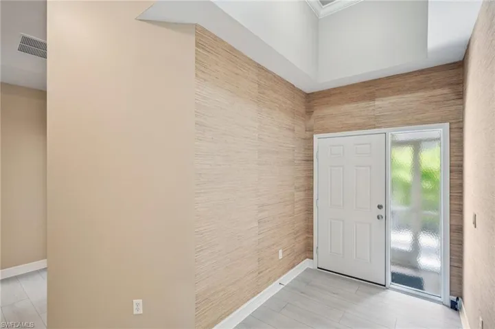 Foyer featuring baseboards and light wood-type flooring