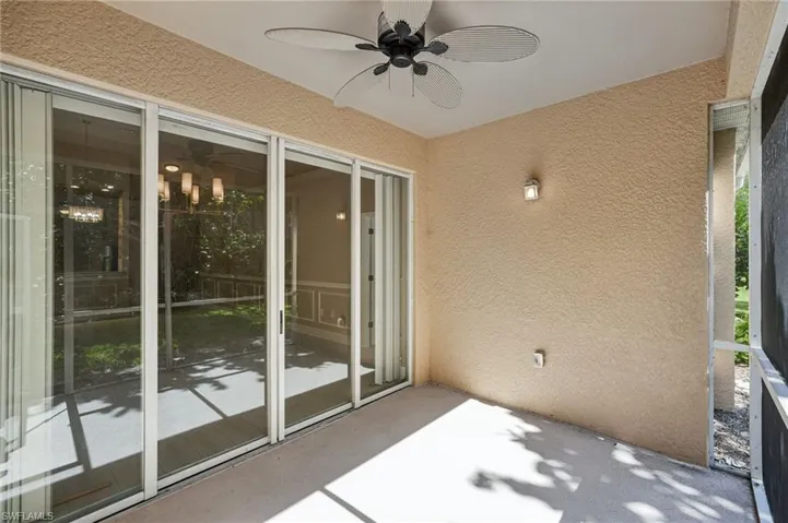 Unfurnished sunroom featuring ceiling fan