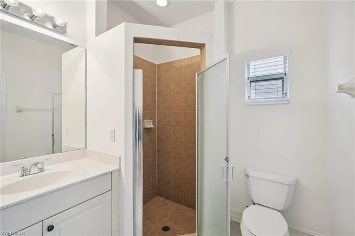 Bathroom featuring vanity and a shower stall