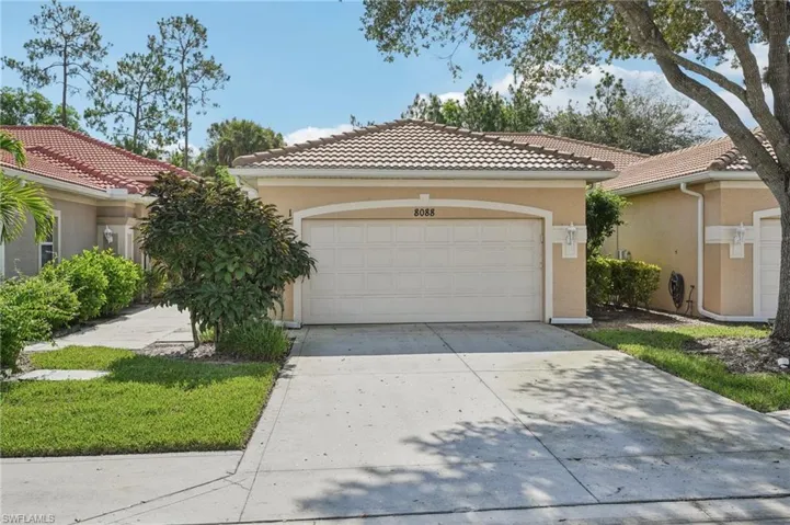 Mediterranean / spanish-style home with concrete driveway, stucco siding, a tile roof, and a garage