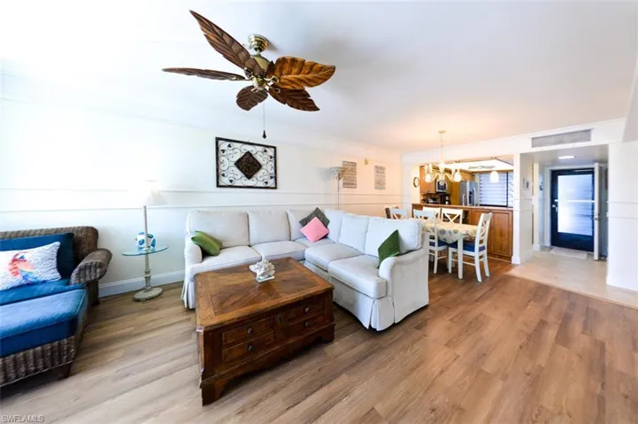 LIVING AREA.  CROWN MOLDING.  LUXURY VINYL WOOD-LOOK FLOORING.