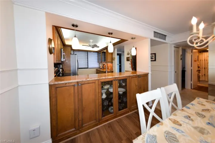 PLENTY OF STORAGE W/CUSTOM CABINETRY.  PENDANT LIGHTING.  ENTRANCE TO GUEST BATH IS SHOWN AT FAR RIGHT.
