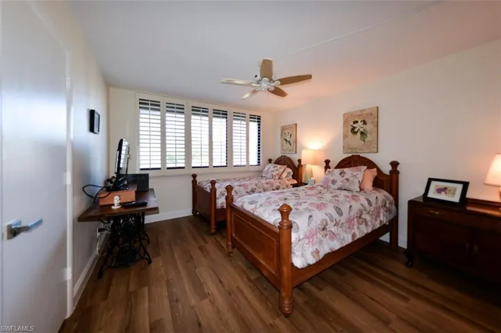 GUEST BEDROOM.  LUXURY VINYL TILE WOOD LOOK PLANK FLOORING.  PLANTATION SHUTTERS.