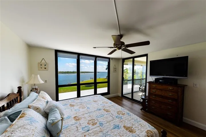 OWNER'S SUITE WITH DIRECT LANAI ENTRANCE.  IMPACT GLASS WINDOWS AND SLIDING DOORS.  ZEBRA BLINDS.