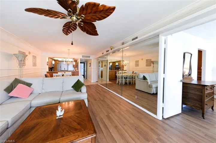 VIEW FROM LIVING AREA TOWARDS KITCHEN/ENTRANCE/GUEST AREA.  ENTRANCE TO OWNER'S SUITE SHOWN AT RIGHT.