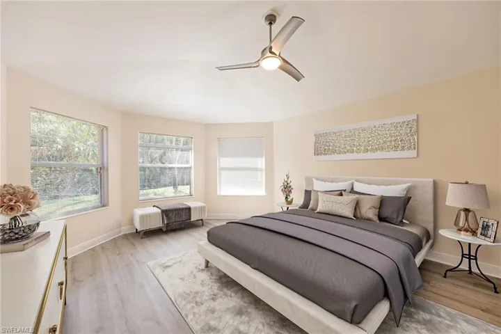 staged Bedroom with light hardwood / wood-style floors and ceiling fan