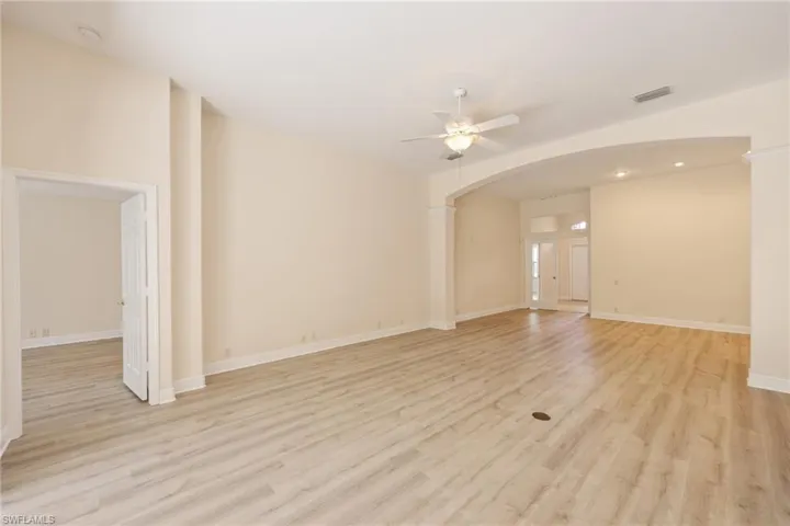 Spare room with light wood-type flooring and ceiling fan