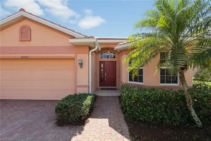 View of exterior entry with a garage