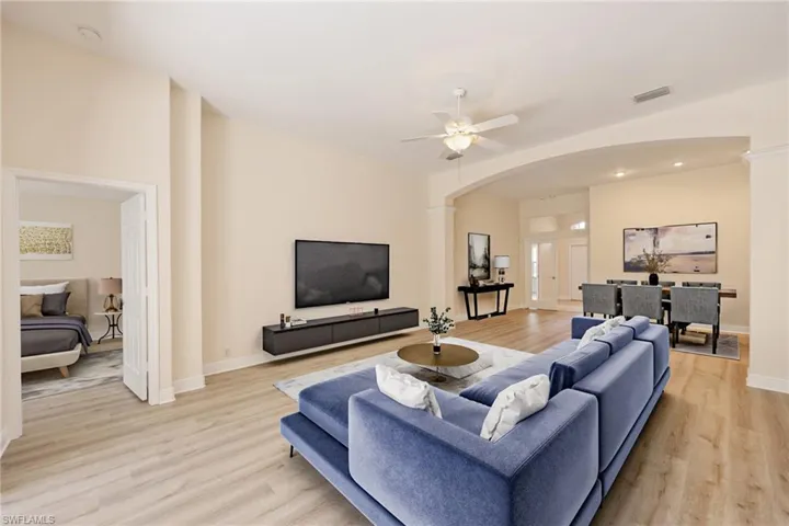 Virtual staged Living room featuring ceiling fan and light hardwood / wood-style floors