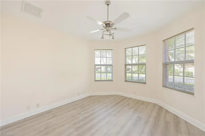 Unfurnished room featuring light wood-type flooring and ceiling fan
