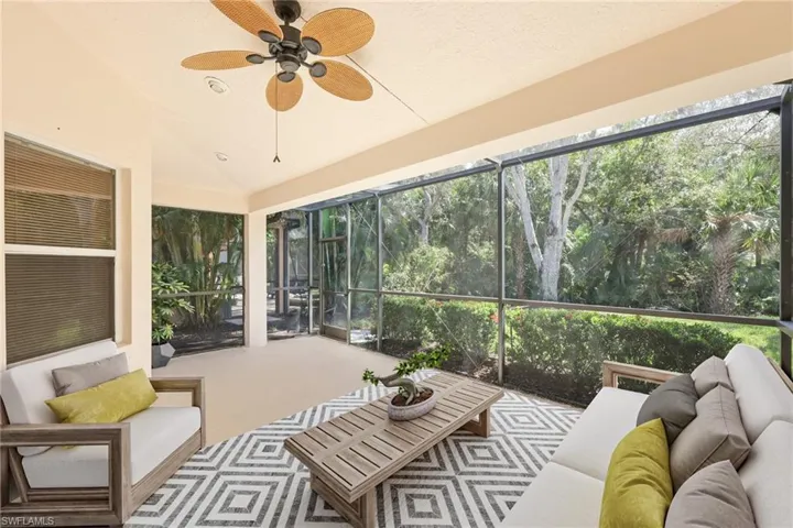 virtual staged Sunroom / solarium featuring ceiling fan and lofted ceiling