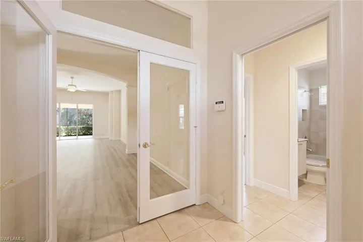 large foyer with french doors light hardwood / wood-style floors