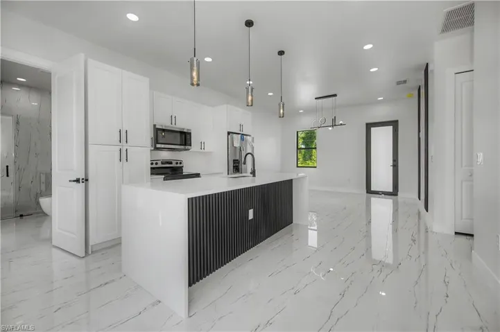 White shaker cabinetry with dark hardware
