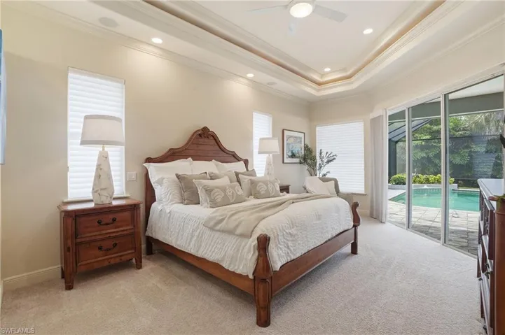 Large Primary w/ Sliders leading to Pool Area, Tray Ceiling w/ Ambient Lighting