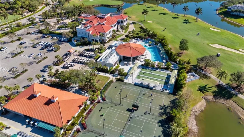 Drone / aerial view with golf course view and a water view