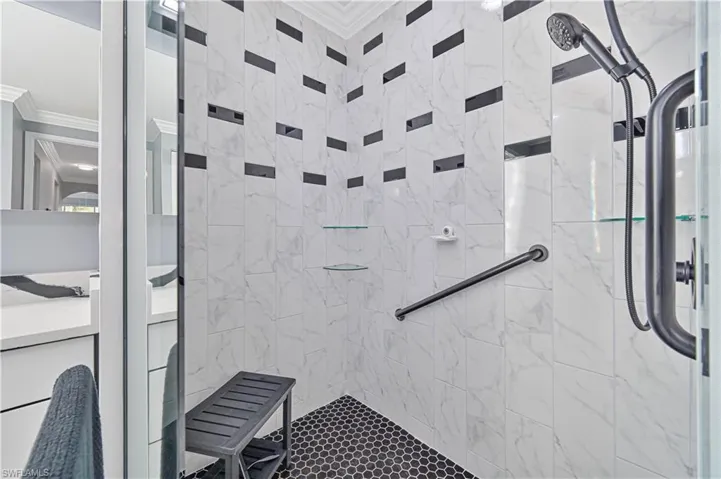 Oversized walk in shower with grab bars and glass shelves !