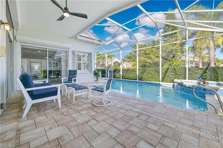 Covered lanai with large sitting area overlooking the pool and  waterfall spa !