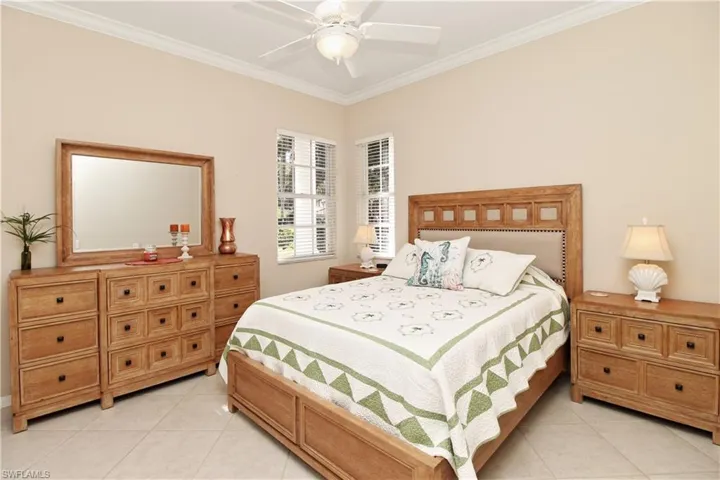 Bedroom featuring ornamental molding, ceiling fan, and light tile patterned flooring