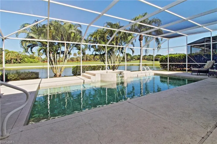 Outdoor pool featuring a lanai, a sunroom, a water view, and a jacuzzi