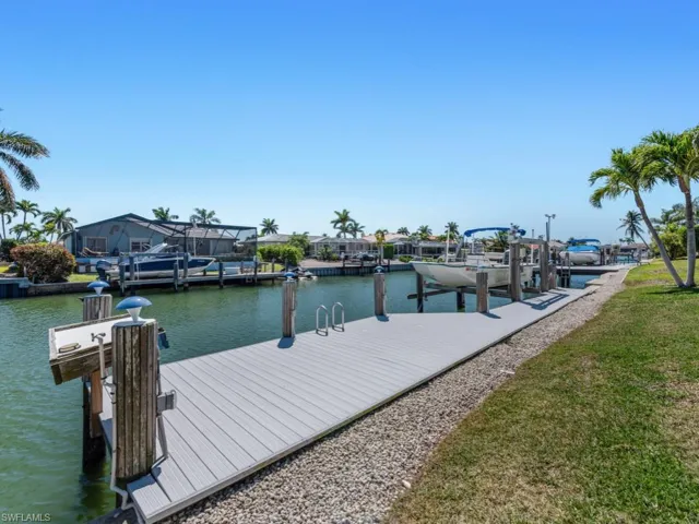 View of dock with a water view and boat lift
