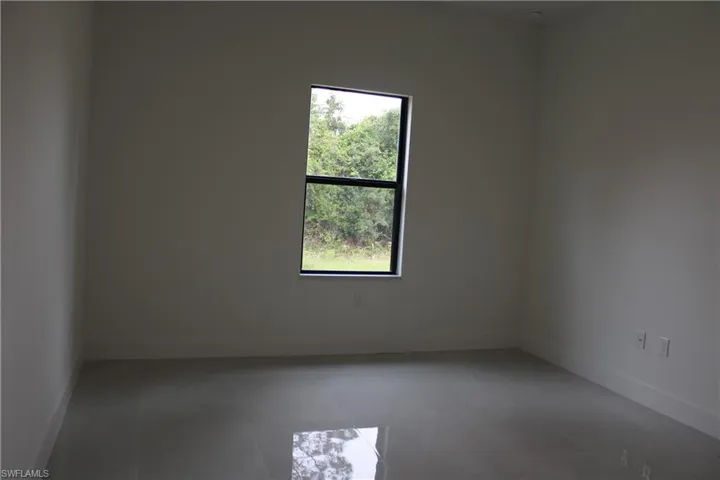 Rectangular window with dark framing and a surrounding natural landscape