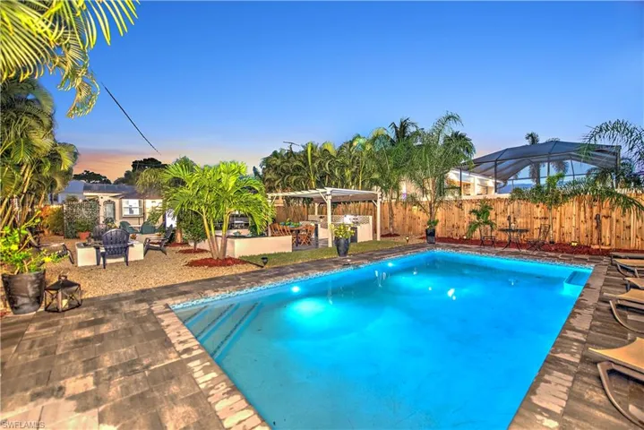 View of patio / terrace with exterior bar and a fenced in pool