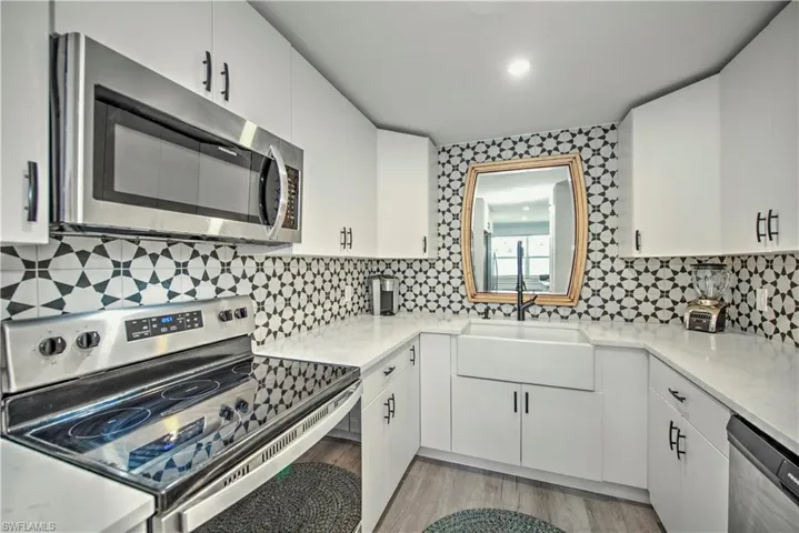 Laundry room featuring stacked washer / dryer