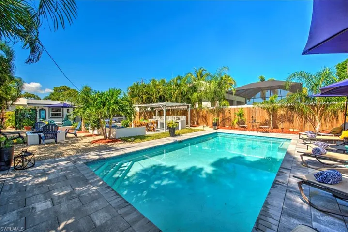 View of yard with a patio, a fenced in pool, and a fire pit