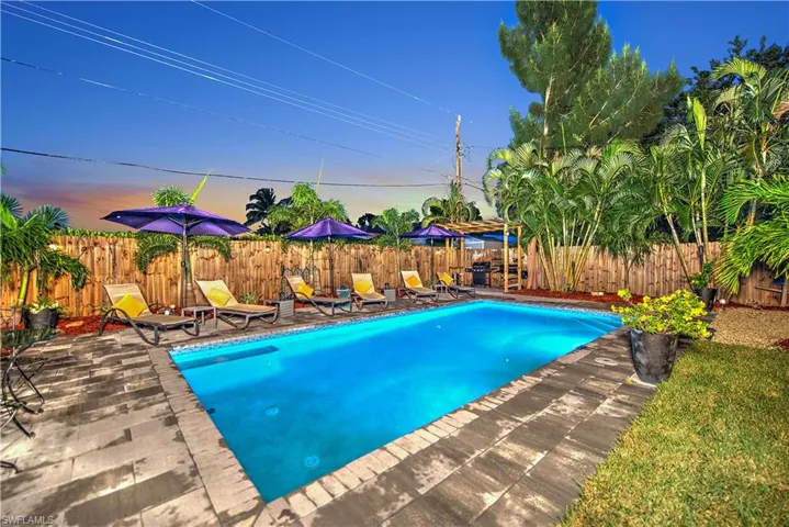 Back of house featuring a pergola, a fenced in pool, and a patio area