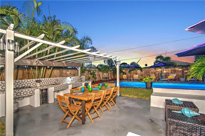 View of pool with a pergola and a patio area
