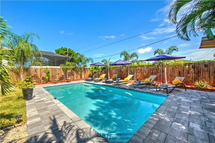 Patio terrace at dusk featuring a fenced in pool and a pergola