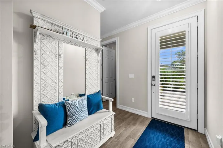 Mudroom with hardwood / wood-style flooring and crown molding