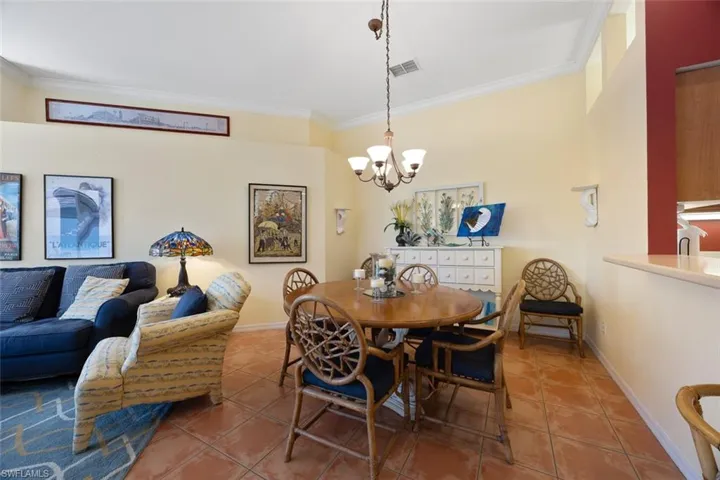 Dining space with baseboards, ornamental molding, visible vents, and tile patterned floors