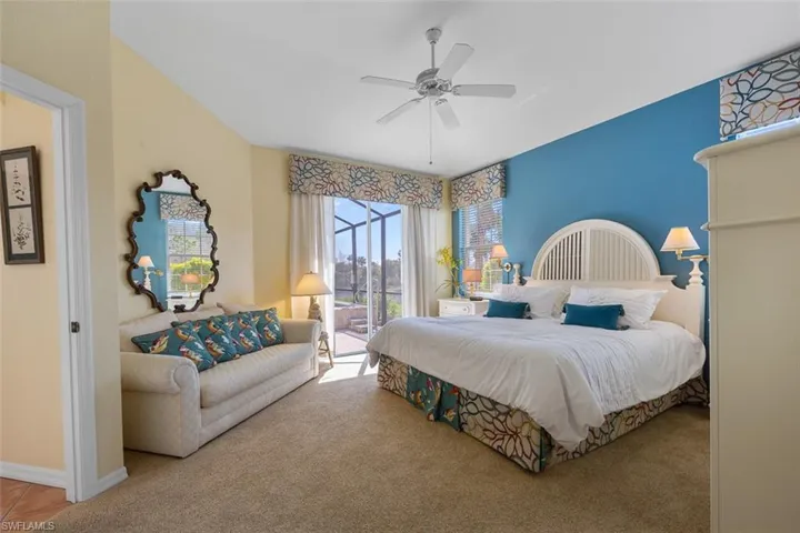 Carpeted bedroom featuring access to exterior, ceiling fan, and baseboards