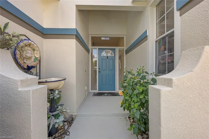View of exterior entry featuring stucco siding