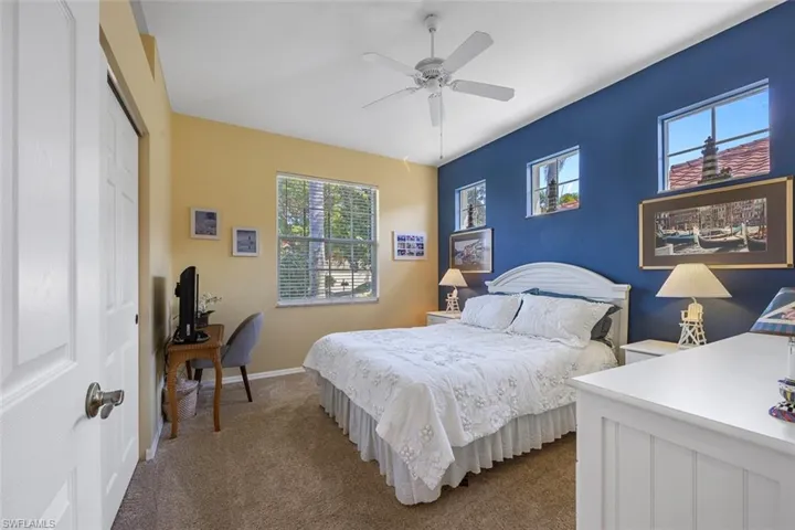 Bedroom with baseboards, ceiling fan, a closet, and light colored carpet