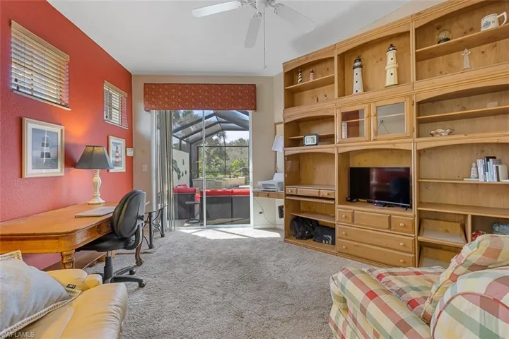 Office area with carpet floors and a ceiling fan