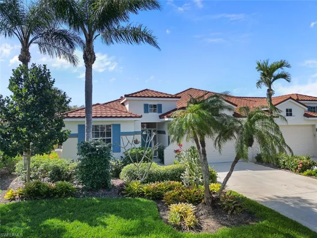 Mediterranean / spanish-style house with a garage, driveway, and stucco siding