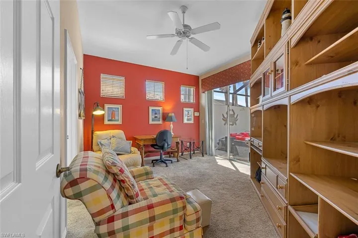 Sitting room featuring light carpet and ceiling fan