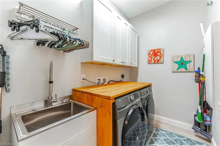 Large laundry room with sink.