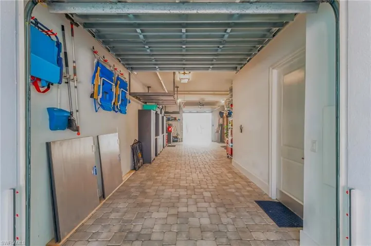 3 car tandem garage with cabinets and workshop.