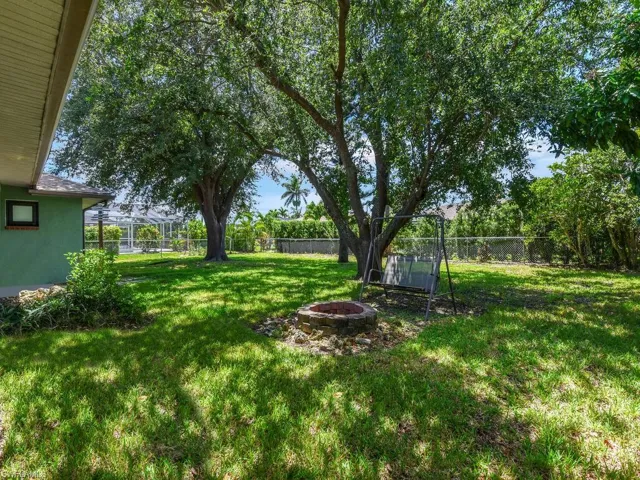 Fenced backyard featuring a fire pit