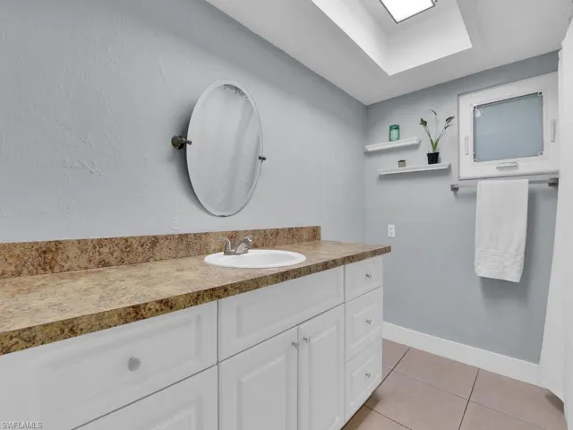 Bathroom featuring tile patterned floors and vanity