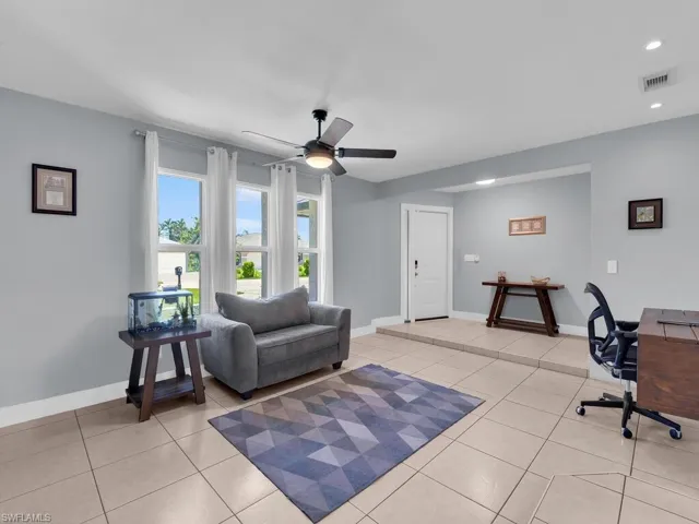 Living area featuring an office area, light tile patterned flooring, ceiling fan, and recessed lighting