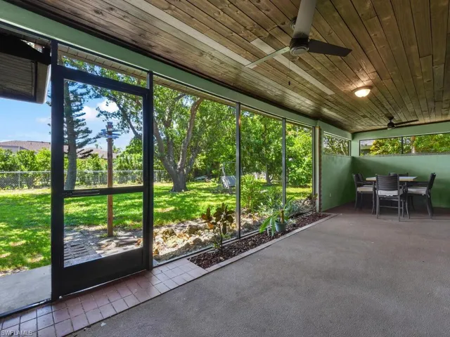 Sunroom / solarium with a ceiling fan and outdoor dining area