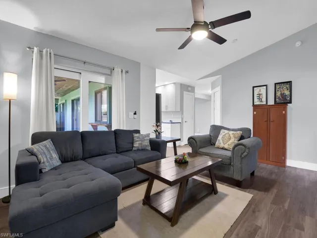Living room with wood finished floors and ceiling fan