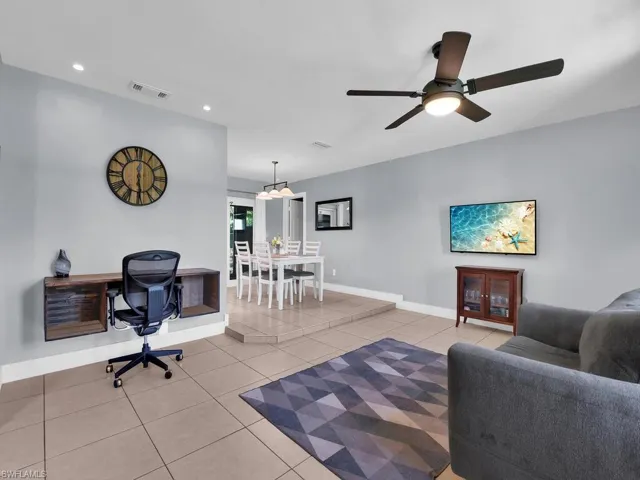 Living room featuring an office area, tile patterned flooring, recessed lighting, and ceiling fan
