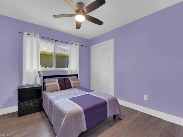 Bedroom featuring wood finished floors, a closet, and a ceiling fan