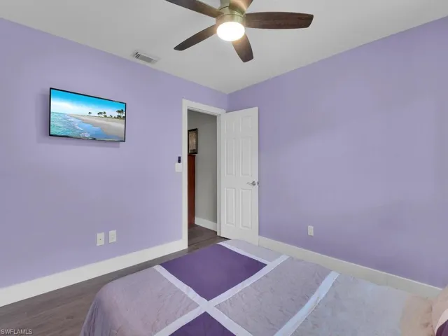 Bedroom featuring wood finished floors and ceiling fan